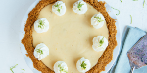 Delicious homemade key lime pie topped with whipped cream and lime zest, served at Mad Hatter Cafe & Bakeshop in Durham